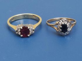 An oval ruby & diamond 14kt ring and a 9ct sapphire & diamond cluster ring. (2)