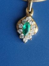 A small modern marquise emerald & diamond cluster 18ct gold pendant on a 375 chain.