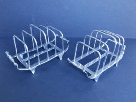 A pair of silver four-division toast racks - D&JW, London 1914, 4.75" across handles. (2)