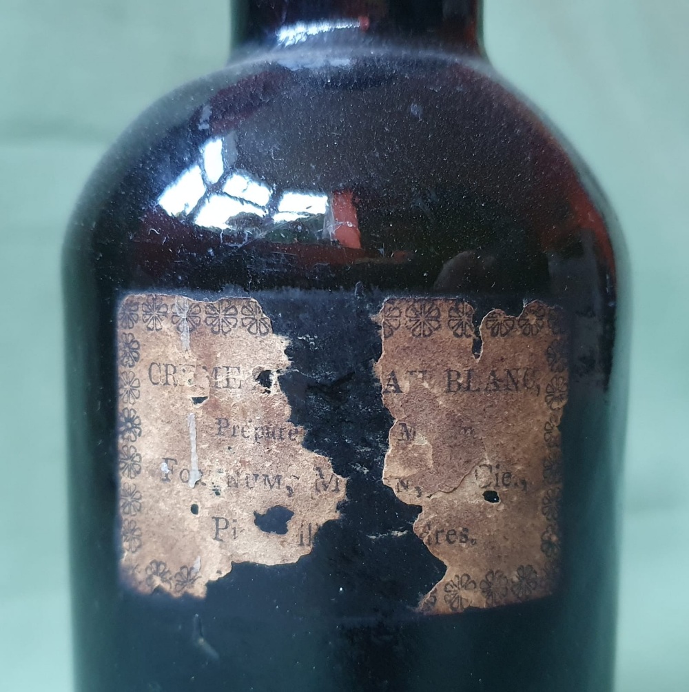 A glass bottle with remains of a paper label - Fortnum Mason, 8" high. - Image 4 of 4
