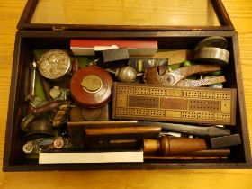 A table-top display case containing a duck-caller, nutcrackers and other collectors' items.