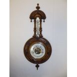 A small Victorian banjo barometer with enamelled dials, 18" high.