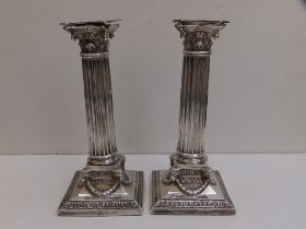 A pair of late Victorian silver Corinthian column candlesticks with detachable sconces - London