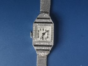 A French Art Deco diamond & onyx set platinum cocktail watch with square white dial.