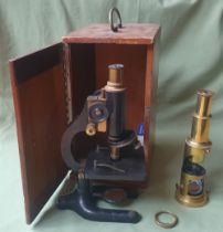 A cased microscope by C. Baker and a brass portable microscope, the smaller 10" high. (2)