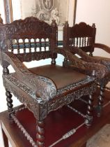 A pair of late 19thC Anglo-Indian armchairs, lady's & gent's, having overall carved decoration,
