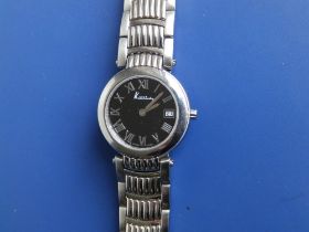 A lady's stainless steel Kutchinsky quartz bracelet wrist watch with black dial, case diameter