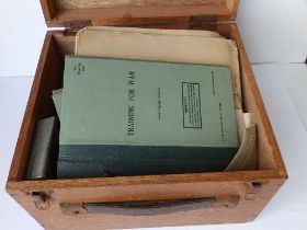 A wooden box containing British War Office Training booklets - 1960, badges and other related