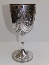 A Victorian silver goblet having repousse oval panels, decorated lily-of-the-valley, bellflowers and