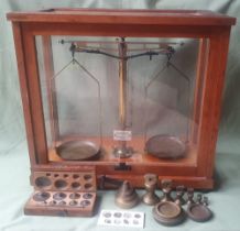 Cased balance scales by Philip Harris with assorted weights, the case 14.5" high.