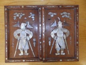 A pair of framed Oriental shell-inlaid wood panels depicting warriors, 17" x 11" overall - slight