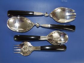 Two pairs of 20thC Eastern white metal salad servers, the larger pair 10.25". (4)