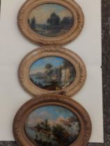 Three oval reverse glass paintings - landscapes with water & figures, the largest 9.5" across.