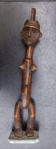 An old African carved wood fertility figure, inset eye details, leaning to left, 22" high.