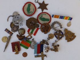 A small collection of military badges , modern coins and other items.