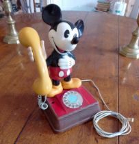 A Mickey Mouse BT telephone, the standing figure with yellow receiver, 15" high.