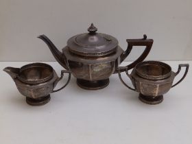 A three piece octagonal silver tea service - Mappin & Webb, Sheffield 1924, the teapot 10.25" across