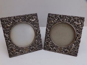 A pair of Edwardian openwork silver square photo frames decorated with cherubs and scrolls - William