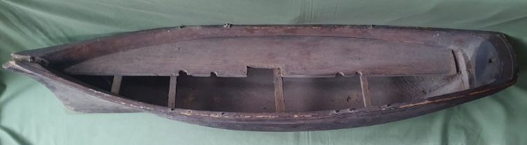 A very large carved wooden hull of a boat made from a single piece of wood, 48".