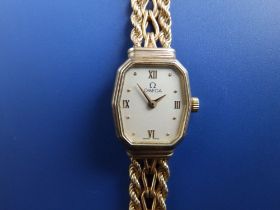 A boxed lady's 9ct gold Omega quartz bracelet wrist watch.