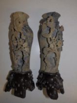 A pair of Chinese soapstone carvings depicting vases of flowers, on stone bases, 10" high. (2)