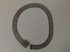 A Malaysian Chinese white metal belt, of open link form with flowerhead buckle, 33".