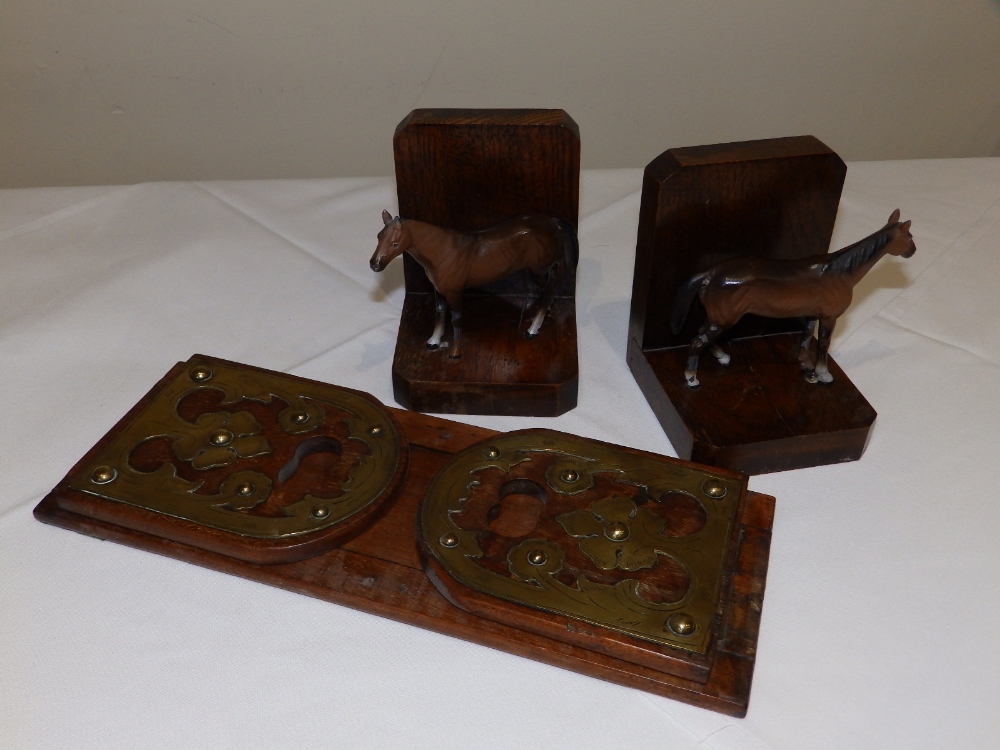 A pair of wooden bookends each mounted with small cold painted lead horse, 5" high together with a