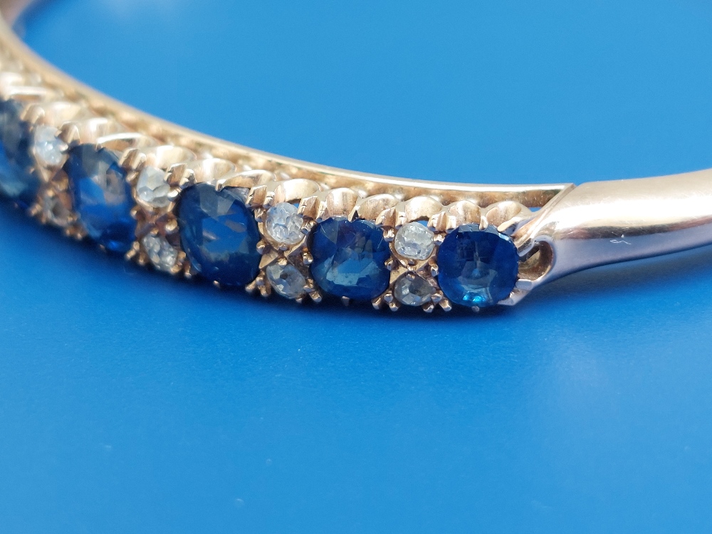 A Victorian sapphire & diamond claw set gold bangle, having nine graduated cushion cut sapphires and - Image 4 of 6