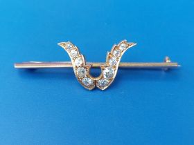 A late Victorian diamond set yellow metal bar brooch, the stones set as a stylised tulip head, 2".