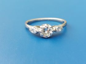 A small diamond set platinum ring, the central claw-set brilliant weighing approximately .50 carat