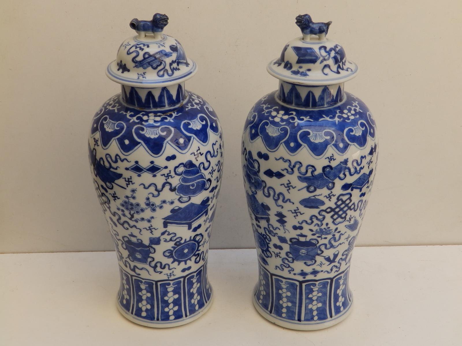 A pair of Chinese blue & white porcelain covered vases, lion finials to lids, the baluster bodies