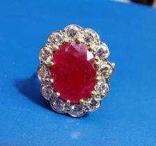 A ruby & diamond oval cluster set 18ct gold ring. Finger size L/M.