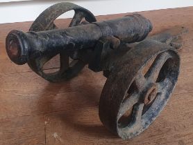A cast iron cannon on carriage, the cannon 17", overall length 26".