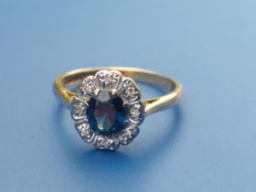 A sapphire & diamond set oval cluster ring in 18ct gold. Finger size K/L.