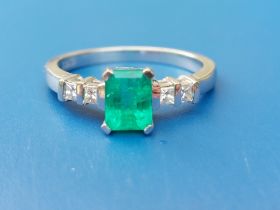 A modern rectangular cut emerald & diamond set 18ct white gold ring. Finger size O/P.