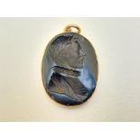 After Nathaniel Marchant - A signed oval glass intaglio pendant in gold mount depicting a profile