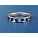 A sapphire & diamond calibre set platinum half eternity ring. Finger size M.