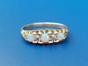 A small late Victorian/Edwardian five stone opal & diamond set 18ct gold ring. Finger size N/O - one