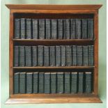 A collection of miniature Shakespeare books in wooden stand.