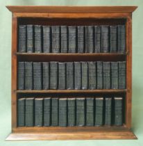 A collection of miniature Shakespeare books in wooden stand.