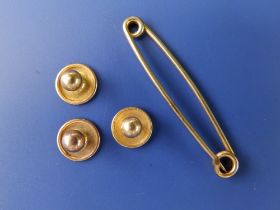 Three 18ct studs and a yellow metal pin. (4)
