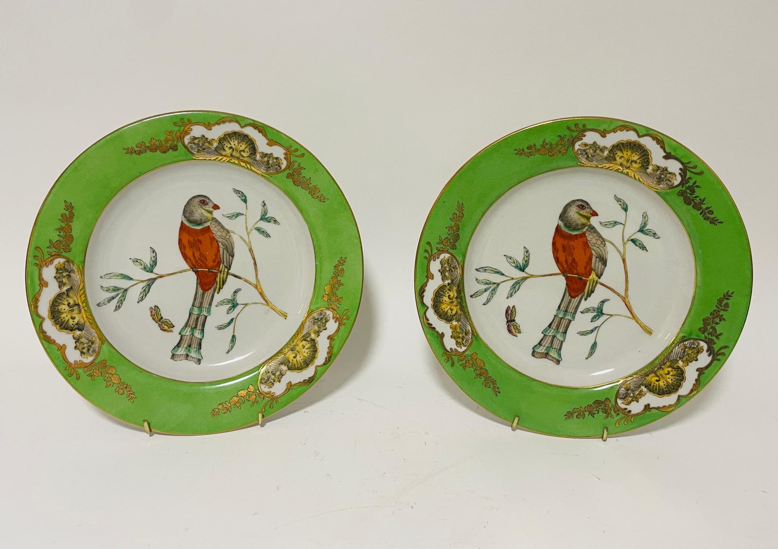 A pair of colour decorated porcelain plates, decorated exotic birds, 10.25" diameter. (2)