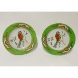 A pair of colour decorated porcelain plates, decorated exotic birds, 10.25" diameter. (2)