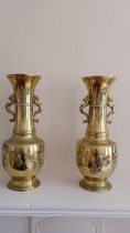 A pair of 19thC Chinese polished bronze vases, having dragon handles, the shouldered bodies with