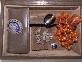 A leather jewellery, four marcasite brooches, two others and a string of irregular amber coloured