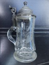 A German engraved glass stein with pewter lid, 9.5" high overall.
