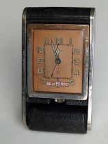 A Jaeger Le Coultre travel clock in folding 'camera' case with rectangular copper dial, 4.75"