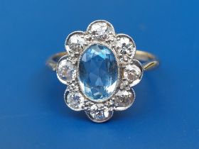 An aquamarine & diamond set '18ct' oval cluster ring. Finger size P/Q.