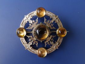 A late Victorian parcel-gilt silver Scottish brooch, of wheel form set with four crowns and five