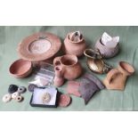A collection of ancient pottery and artefacts including Roman ceramics, Mesopotamian stone jar and